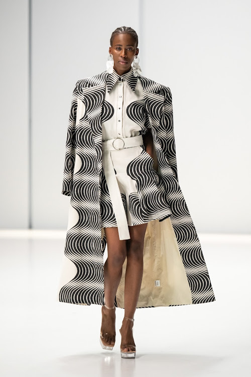 Model walking in a monochromatic tribal print look during The Bam Collective SA Fashion Week Spring Summer 2024 runway.