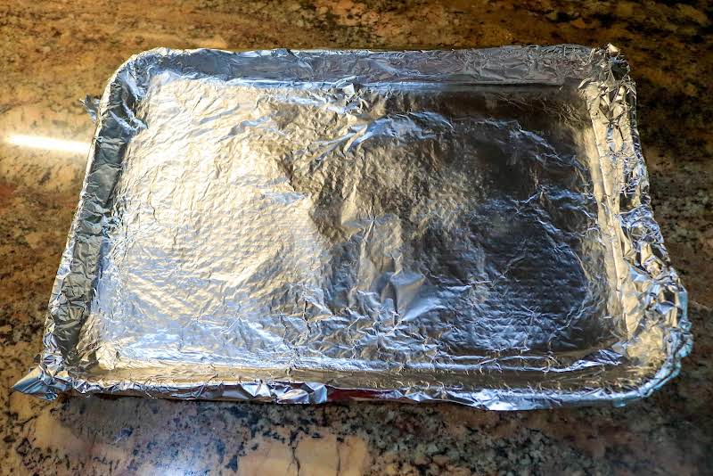 Baking Sheet Lined With Aluminum Foil And Coated In Non-stick Spray.