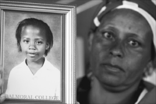 MISSING: Johanna Gumede, Damaries's mother, with a picture of her missing child. Pic: Antonio Muchave. Circa February 2010. © Sowetan Johanna Gumede. mother of Damaries, the 10-year-old girl of Rondebult in Ekurhuleni,who went missing six weeks.