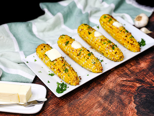 A platter of Roasted Corn With Garlic and Olive Oil.