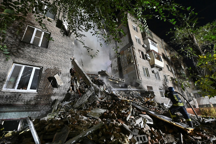 A rescuer works at a site of a residential building heavily damaged by a Russian missile strike, amid Russia's attack on Ukraine, in Zaporizhzhia, Ukraine October 10, 2022.