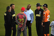 Umpires discuss the weather conditions with the captains before calling off the MSL match between the Tshwane Spartans and the Nelson Mandela Bay Giants in Pretoria on Wednesday.