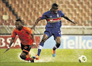 WET AND WILD: Polokwane City's Roger Majafa, left, and University of Pretoria's Ronald Ketji fight for the ball in their Absa Premiership match at Peter Mokaba Stadium  yesterday
      Photo: Philip Maeta/Gallo Images