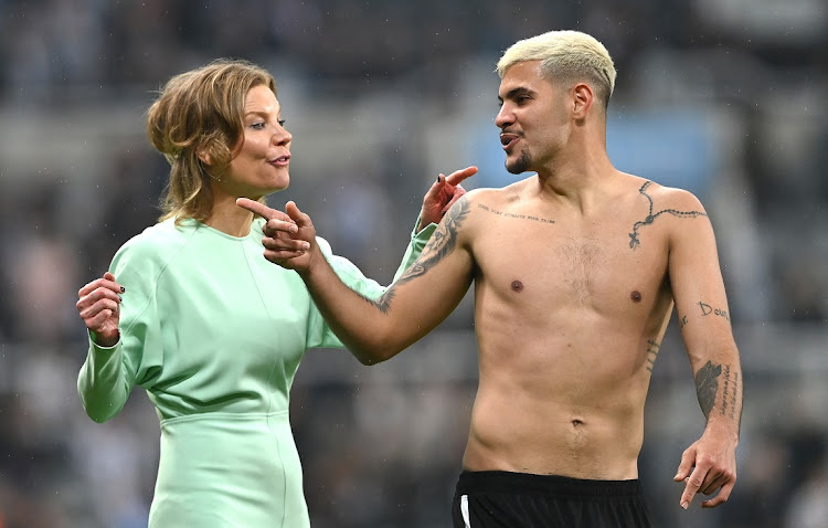 Newcastle player Bruno Guimaraes shares a joke with co-owner Amanda Staveley on the pitch after the Premier League match between against Arsenal at St James Park in Newcastle upon Tyne on May 16 2022.