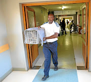 SPCA's Inspector Mishack Matlou with one of the 14 cats that were caught at  Mmametlhake Hospital.  