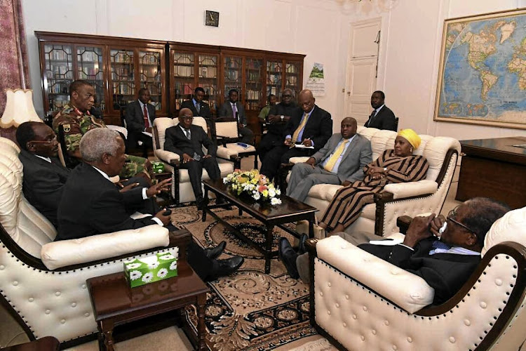 State Security Minister Bongani Bongo, in the grey suit, alongside Defence Minister Nosiviwe Mapisa-Nqakula. The two were part of the South African team sent to meet Robert Mugabe, right, and military leaders in Zimbabwe last week.