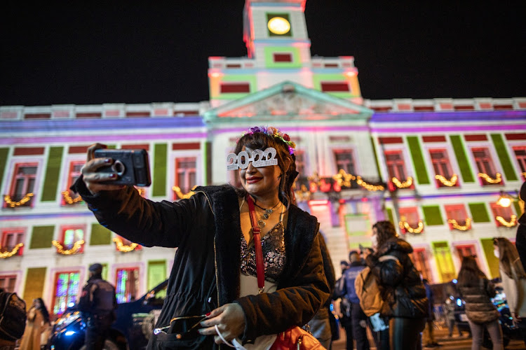 A woman poses for a selfie at Puerta del Sol Square in Madrid, Spain, on New Year's Eve on December 31 2021.