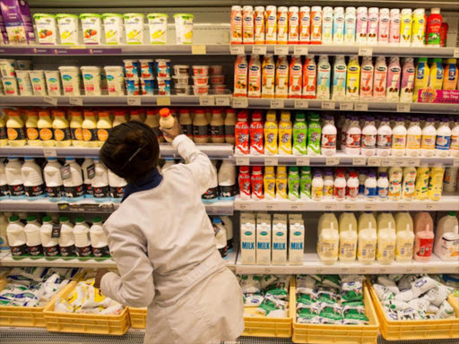 An employee restocks the dairy products section at a supermarket in Nairobi, Kenya May 8, 2017. /REUTERS