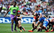 Ivan van Zyl of the Bulls gets his pass away as referee Rasta Rasivhenge looks on.