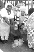 HEATED UP: The bitterly cold weather forced hawkers to gather around a brazier to keep warm in Polokwane. They are Magi Pheme, Francinah Mashala and Maria Maudae. Pic. Elijar Mushiana. 22/05/2007. © Sowetan.