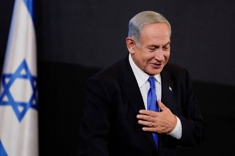 Likud party leader Benjamin Netanyahu gestures to his supporters at his party headquarters during Israel's general election in Jerusalem, November 2, 2022.