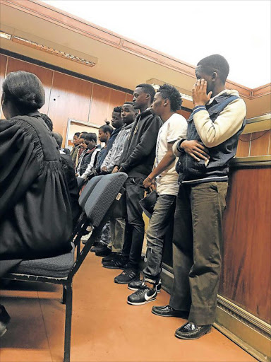 FACING THE MUSIC: From right to left, Siyavuya Mabongo, 19, Siphamandla Blom, 20, Xolisa Mncininto, 18, Sibahle Jebe, 18, Abongile Stefane, 20, Grace Ruiters, 20, Nangamso Thembalipheli, 22, Olwethu Ndamazi, 22, Wanda Mangolithi, 19 and Awonke Philisani, 21, appear in the East London Magistrate’s Court Picture: ZWANGA MUKHUTHU