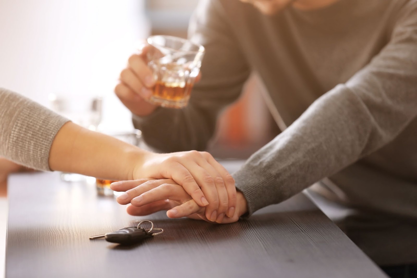 A woman preventing drunk man from driving.