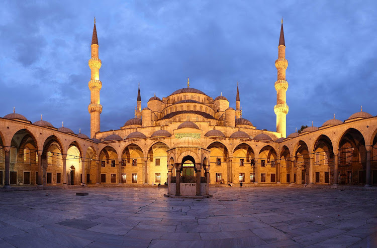 The courtyard of the Blue Mosque, or Sultan Ahmed Mosque, at dusk in Istanbul. 