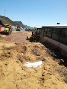 The mud buried a white Toyota Conquest before the torrent was stemmed.