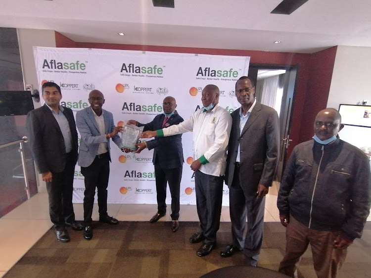 FROM LEFT: Nishant Pahuja; Arysta General Manager, Charles Macharia; Koppert General Manager, Joseph Kimote; NCPB MD, John Matiri NCPB General Manager, Patrick Amuyunzi; Arysta Commercial Manager, Josephat Muvevi; NCPB Regional Manager posewith a packet of aflasafe at EKA hotel.