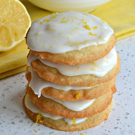 These delectable Iced Lemon Cookies are soft on the inside with slightly crispy edges all topped with a four ingredient light sweet lemon glaze.  