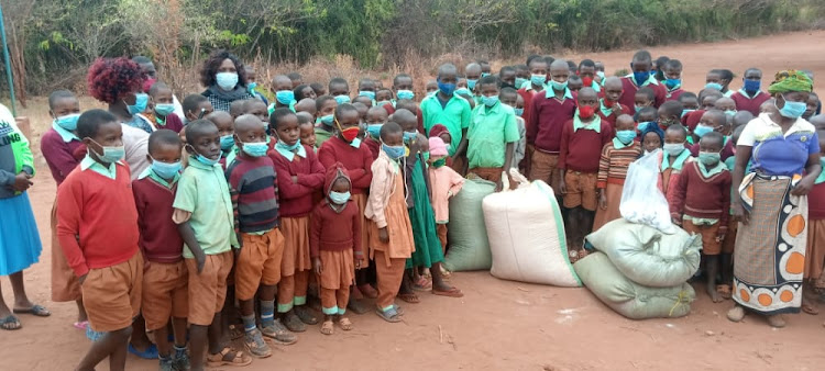 The Kalimamundu Primary School fraternity mill around the four bags of maize stuff donation made to the school by well-wishers on Wednesday morning.