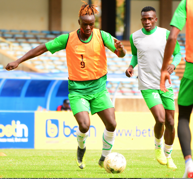 Harambee Stars' John Avire (L) dribbles the ball past Philemon Otieno during a training session at Moi Kasarani on Thursday.