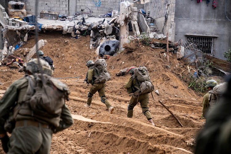 Israeli soldiers operate in the Gaza Strip amid the ongoing conflict between Israel and the Palestinian Islamist group Hamas, in this handout picture released on December 30 2023.