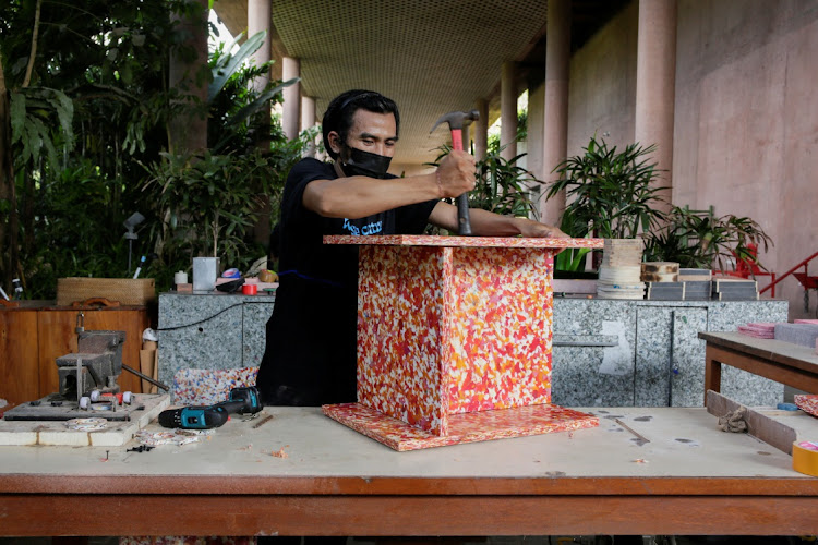 In the run-up to Earth Day on Saturday, Gede Sapta Wiguna assembles a plastic recycled chair at the waste production station of Potato Head Beach Club and Hotel in Bali, Indonesia.