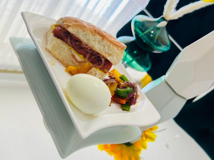 Homemade sandwich served with pan fried veggies and a boiled egg