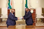 Chief justice Raymond Zondo hands over a copy of his report on state capture to President Cyril Ramaphosa. Parliament has clarified it expects Ramaphosa to submit the report's implementation plan four months from June 15, which is October 15.
