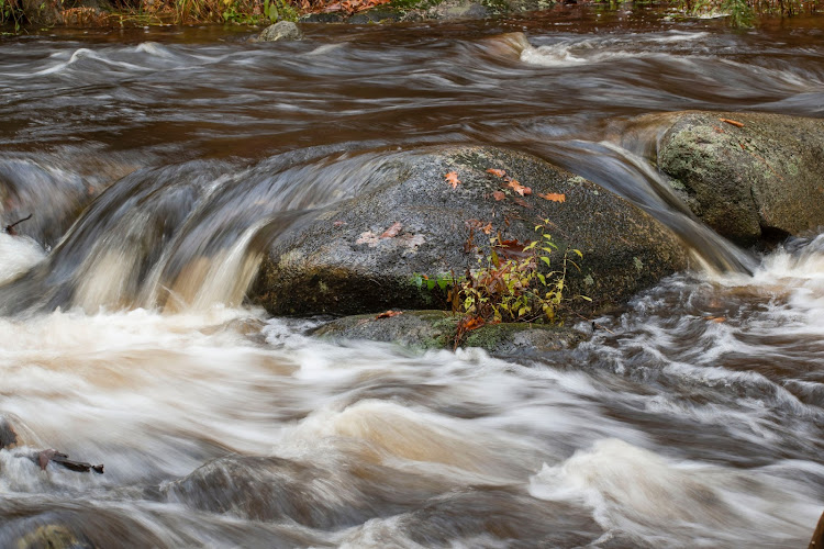 The hikers found themselves trapped between two fast-flowing rivers. Stock photo.