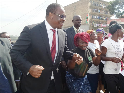 Nairobi governor Evans Kidero is welcomed in Mathare slum where launched water ATM cards. photo/PATRICK VIDIJA