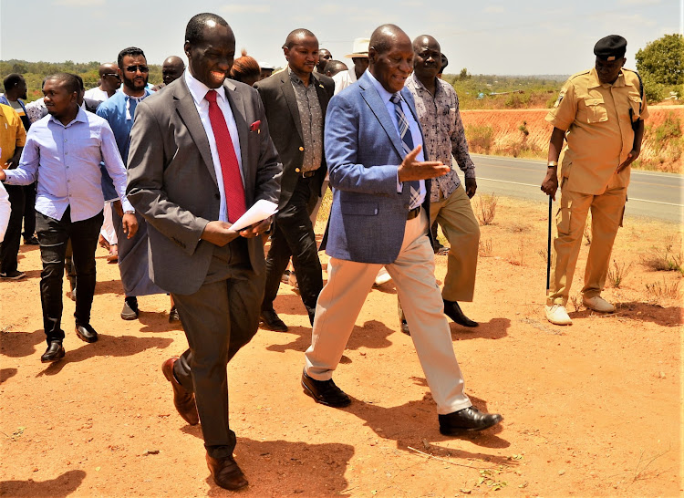 Kitui Judge Justice Robert Limo and Kitui Governor Julius Mlaombe when they visit the plot of land at Manyenyoni where two actres have been set aside for the expansion of the law courts.