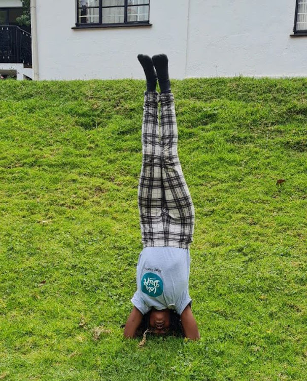 Mwihaki doing a headstand after teaching Yoga to a corporate group at Thayu farm in Tigoni.