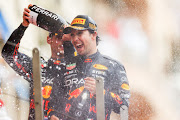 Sergio Perez celebrates on the podium with Max Verstappen after winning the F1 Grand Prix of Monaco at Circuit de Monaco on May 29, 2022 in Monte-Carlo, Monaco.