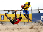 Nelson Manuels of Mozambique is blocked by Ismail Gambo of Tanzania during the COSAFA Beach Soccer Tournament in Durban. Photo: SANDILE NDLOVU