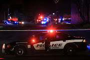 A police officer sits in their vehicle while responding to a mass shooting at the Club Q gay nightclub in Colorado Springs, Colorado, US, on November 20 2022. 