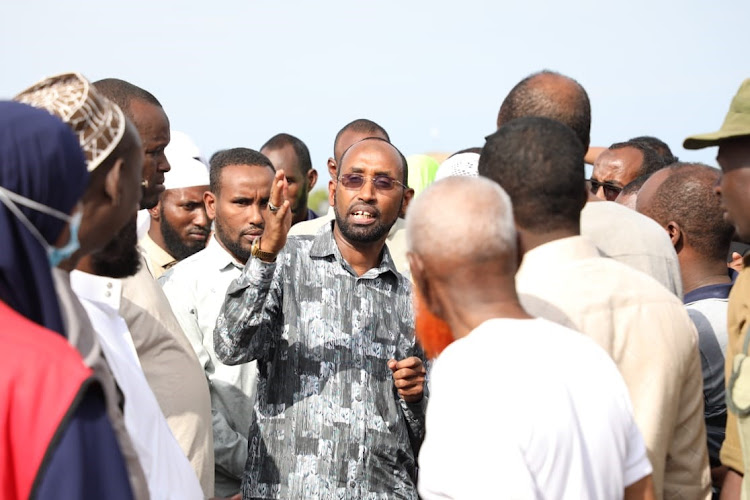 Mohamed Adan Khalif has a word with other leaders and residents of Bula Barwaqo when he went to assess the flood situation in the area.