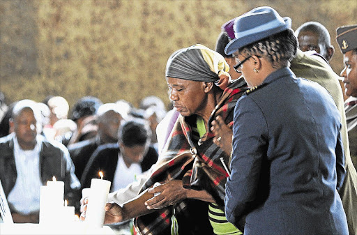 Family of the South African soldiers who died in the Central African Republic light candles at the memorial service at the AFB Swartkop military air force base in Centurion, Pretoria.