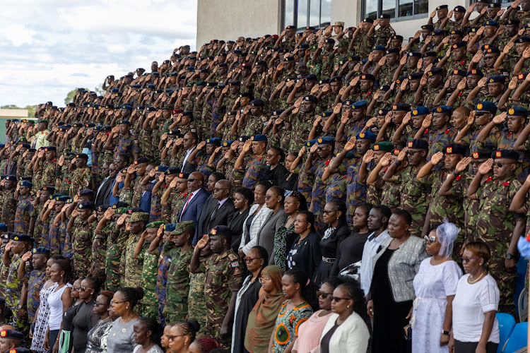 Military officers salute during the playing of the national anthem at the Ulinzi sports complex on April 20,2024.