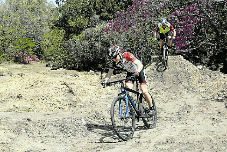 Michael Butcher, in a green shirt, and his son Matthew, wearing red and black gear, test out their newest addition to the mountain bike track at Floradale Nursery. Butcher and his son built the track over a year ago and recently added a kid’s loop to give families and less experienced riders an opportunity to enjoy the ride too.