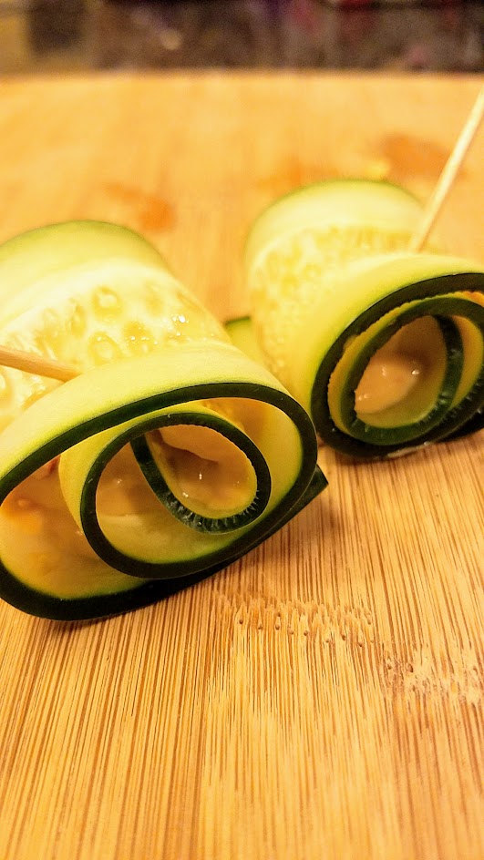 Slice cucumbers the long way to make cucumber roll ups for a healthy, vegetarian, gluten free bunch of bites for a party