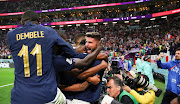 Olivier Giroud of France celebrates scoring the winning goal with teammates in front of photographers in their World Cup quarterfinal win against England at Al Bayt Stadium in Al Khor, Qatar on December 10 2022.