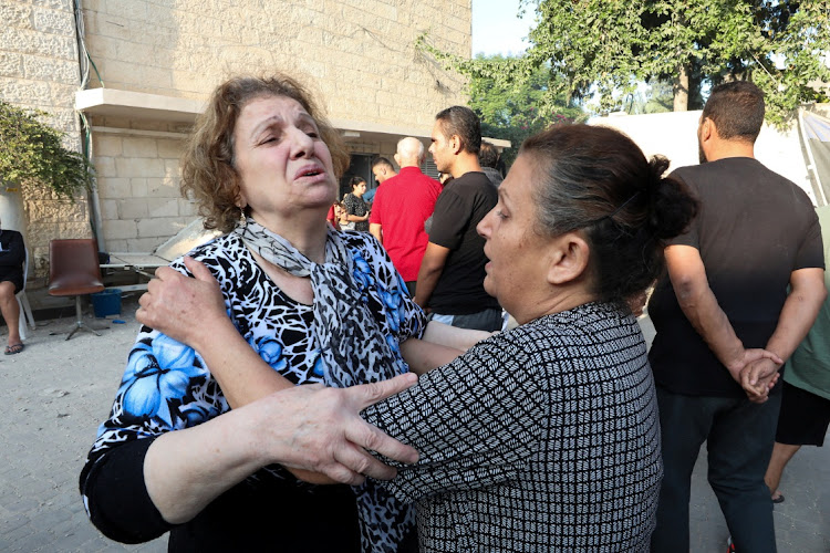 Women react at the Greek Orthodox Saint Porphyrius Church which was damaged by an Israeli strike, where Palestinians who fled their homes take shelter, in Gaza City, on October 20 2023.