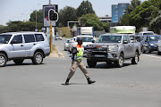 A Johannesburg Metropolitan Police Department (JMPD) officer directs traffic in Fourways, Johannesburg, during load-shedding.