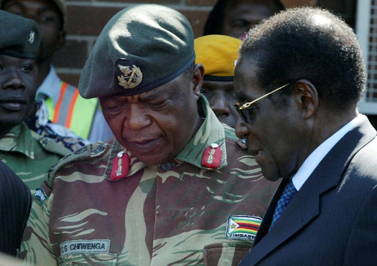 President Robert Mugabe talks to General Constantino Chiwenga in Harare, Zimbabwe, July 4, 2008.