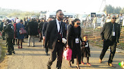 Family members arriving at Mama Winnie's home.