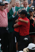 Tiger Woods embraces his son Charlie Axel as his daughter Sam Alexis (R) looks on after he won the 2019 Masters. 