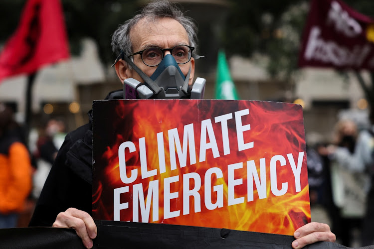 A climate activist wearing a face mask. Picture: AMR ALFIKY/REUTERS