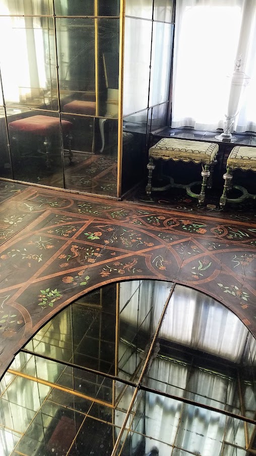 Visiting Rosenborg Castle in Copenhagen. The Mirror Cabinet room was furnished for Christian V, and is a room mirrors were everywhere, on the ceiling, the walls and in the oval mirror in the flooring probably intentionally as a way to look up the skirts of female visitors. In hidden cupboards the king has both a fold out bed or an escape staircase.