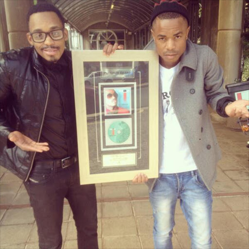 Donald Moatshe and manager with his platinum album