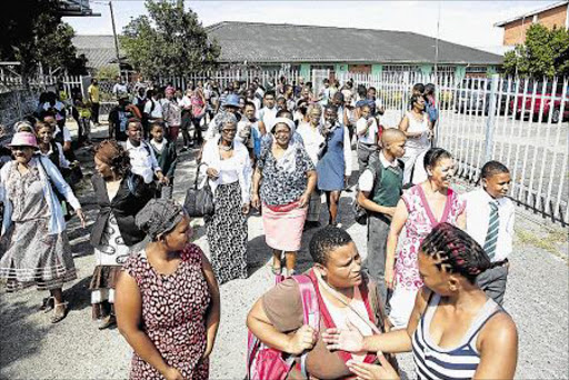 DESPERATION: Parents and their children pupils from John Bisseker who have not been able to secure placement at schools this year met at the outside John Bisseker Senior Secondary School yesterday