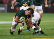 Franco Mostert of South Africa tackled by Mako Vunipola of England during the international rugby match between South Africa and England at Ellis Park, Johannesburg on June 9 2018.